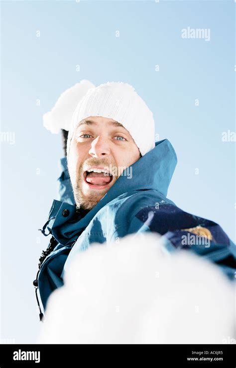 Man Throwing Snow Ball Stock Photo Alamy