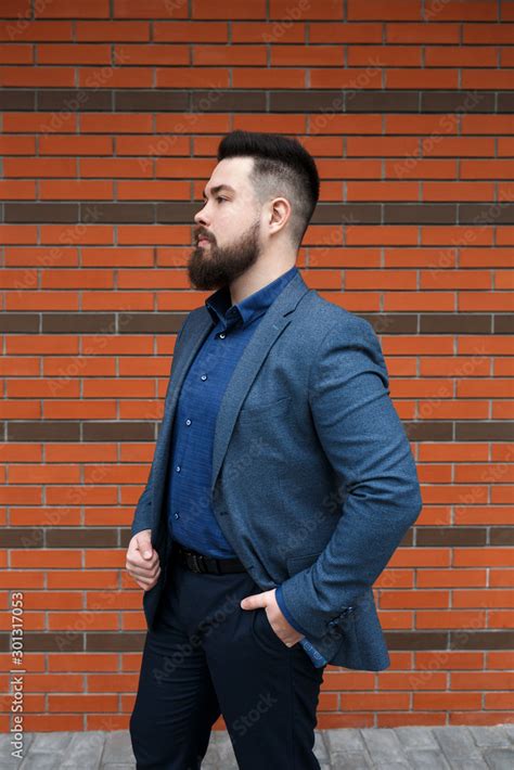Stylish Handsome Brunette Man With Beard Wearing Blue Suit Jacket
