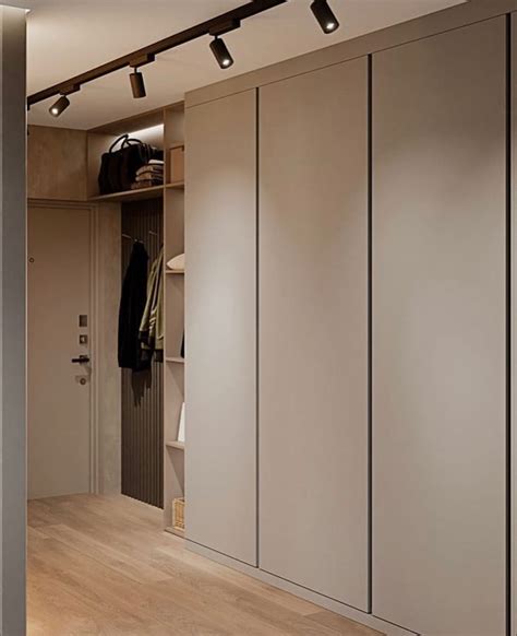 An Open Closet With Clothes Hanging From The Ceiling And Lights On The