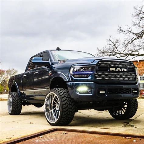 Black Ram Truck Parked In Front Of A House