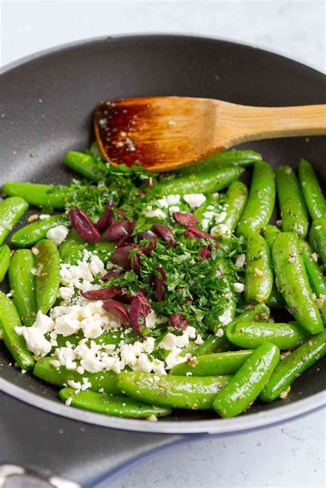 Fresh Sautéed Sugar Snap Peas Combined With Creamy Feta Cheese Briny Olives And Zesty Garlic