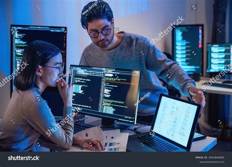 asian indian developer devops team discussion stock photo
