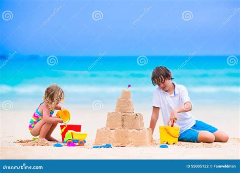 Cute Kids Building Sand Castle On The Beach Stock Photo Image Of