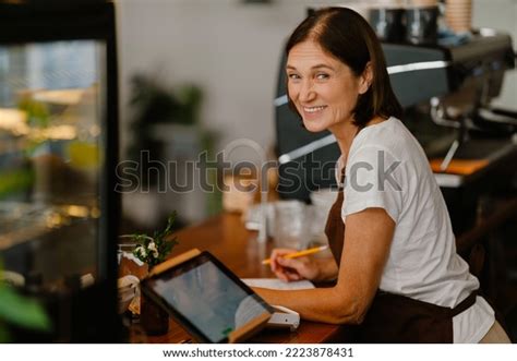 White Mature Barista Woman Smiling While Stock Photo 2223878431