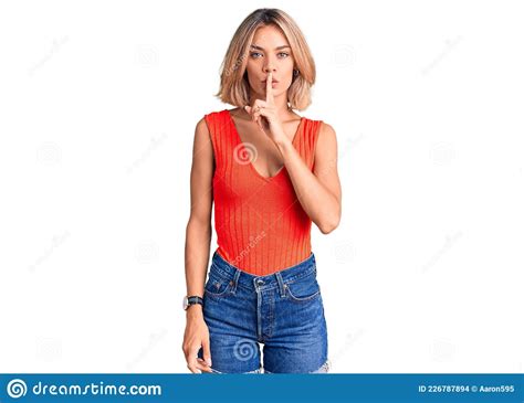 Beautiful Caucasian Woman Wearing Casual Clothes Asking To Be Quiet With Finger On Lips Stock