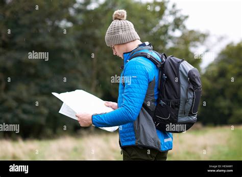 Hiker Looking At Paper Map Stock Photo Alamy