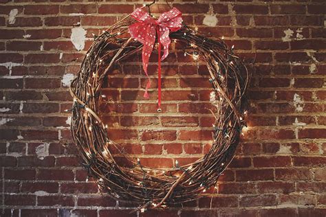 Christmas Holiday Wreath With A Red Bow And Festive White Lights By