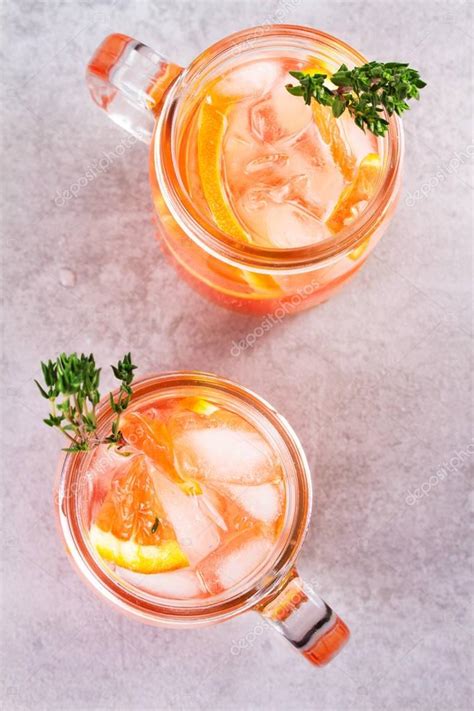 Campari and vermouth cocktail with oranges, garnished with thyme ...