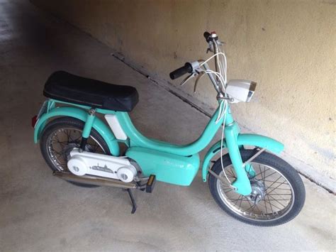 A Blue Scooter Parked Next To A Wall In A Parking Garage With No One On It