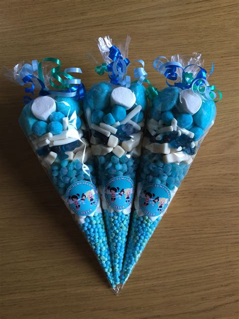 Three Candy Cones With Blue Candies In Them