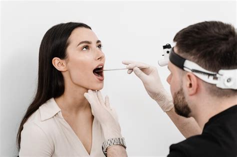 Premium Photo Ent Doctor Examines Woman Throat With Spatula