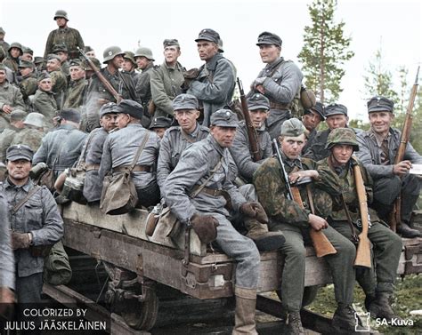 Finnish Soldiers And German Waffen Ss Volunteers On A Rail Cart In