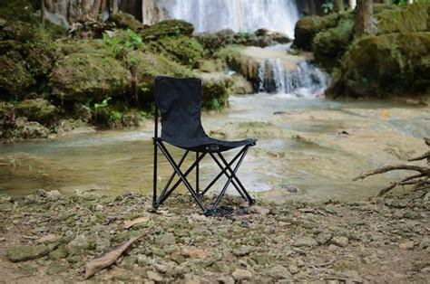 Premium Photo Fishing Chair With Beautiful Waterfall Backdrop In