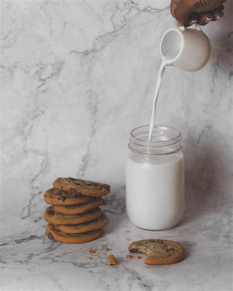 Person Pouring Milk In Highball Glass · Free Stock Photo