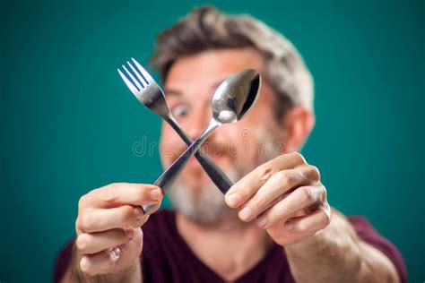 A Portrait Of Bearded Man Holding Spoon And Fork In Hands People And
