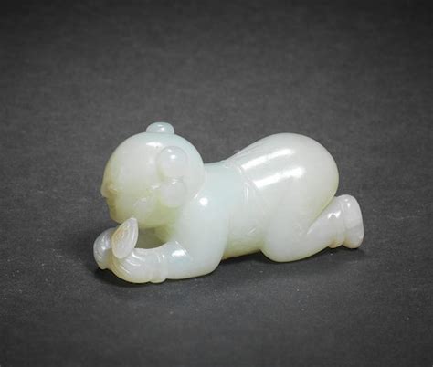 Bonhams : A RARE VERY PALE GREEN JADE CARVING OF A BOY 18th century