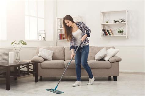 Young Woman Cleaning House With Mop Young Woman Cleaning House