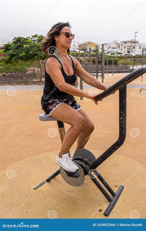 Attractive Middle Aged Woman Doing Gymnastic Exercises In An Outdoor