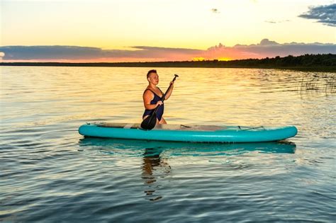 Premium Photo A Woman In A Bathing Suit With A Mohawk Sits On A Sup