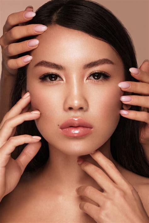 Beautiful Delicate Woman Of Oriental Type With Nude Makeup And Perfect