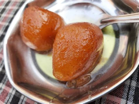 An Indian Sweet Dish Beautifully Garnished With Sugar Syrup In A Plate