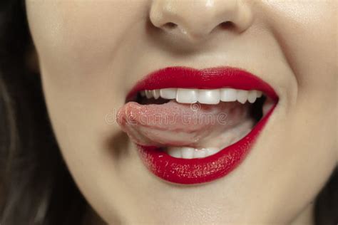 smiling girl opening her mouth with red lips and showing the long big giant tongue isolated on