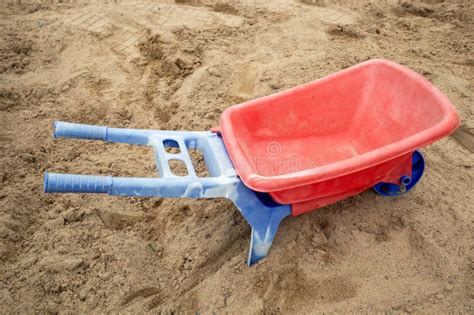 Plastic Toy Wheelbarrow In A Sandbox Outdoors Stock Photo Image Of