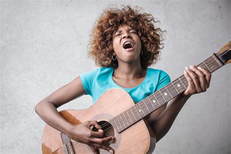 Woman Playing Acoustic Guitar While Singing · Free Stock Photo