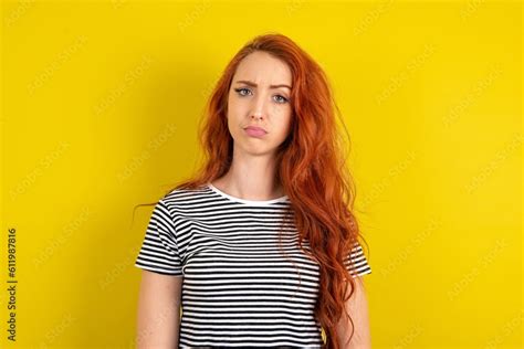 Displeased Young Beautiful Red Haired Woman Wearing Striped Shirt Over