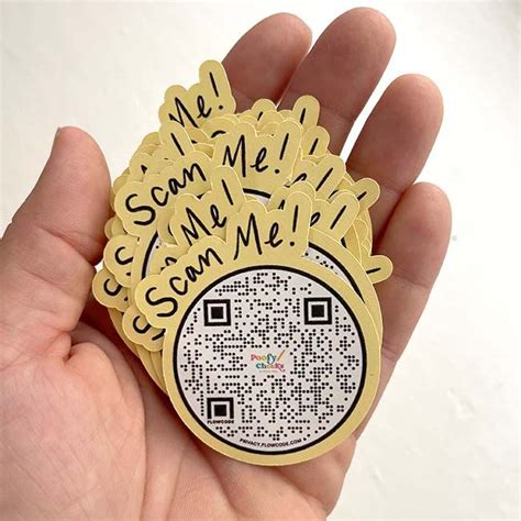 Someone Is Holding Up A Qr Code Sticker That Says We Scan Me With