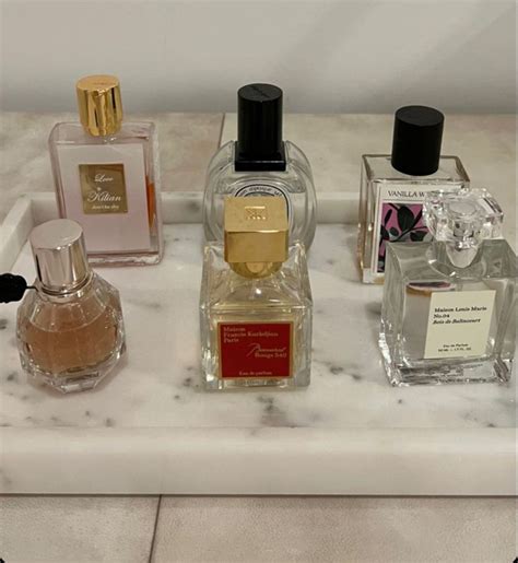 Three Different Types Of Perfume Bottles On A Marble Counter