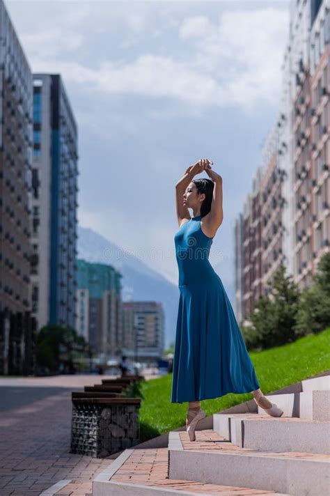 Beautiful Asian Ballerina In Blue Dress Posing On Stairs Outdoors