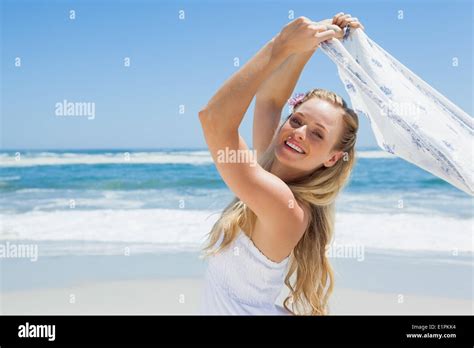 Pretty Carefree Blonde Posing On The Beach With Scarf Stock Photo Alamy