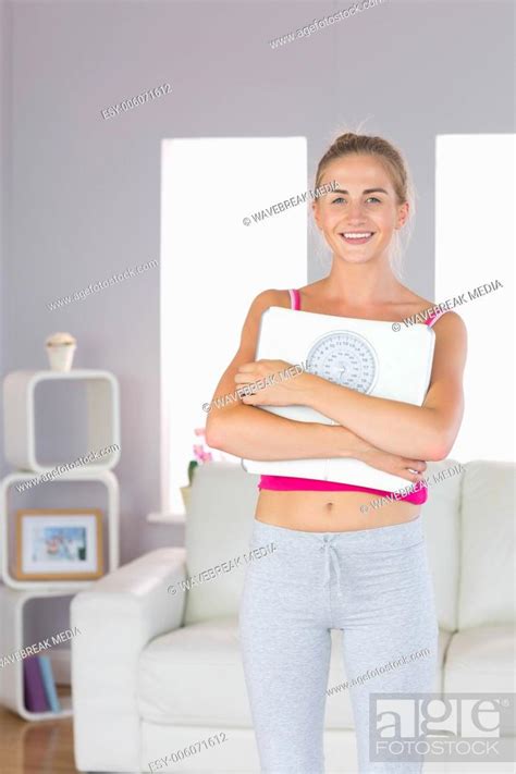 Sporty Cheerful Blonde Standing Cross Armed Holding Scales Stock Photo