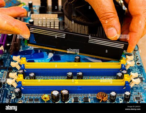 Put computer memory DDR RAM in the slot of motherboard Stock Photo - Alamy