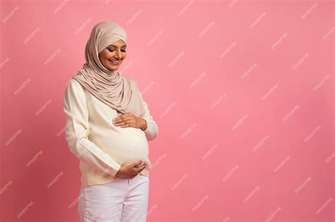 Premium Photo Beautiful Pregnant Muslim Lady In Hijab Embracing Her