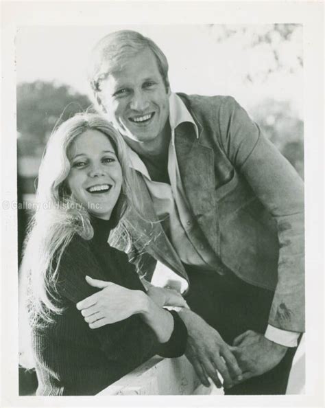 black and white photograph of two people smiling for the camera, one ...