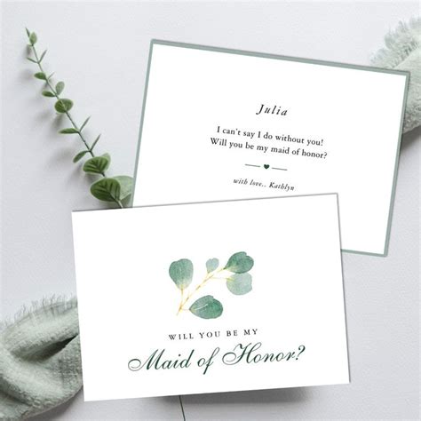 Two Cards With The Words Will You Be My Maid Of Honor And Green Leaves