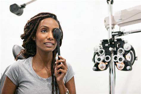 Eyewear Woman Uses Eye Occluder During Exam By Stocksy Contributor