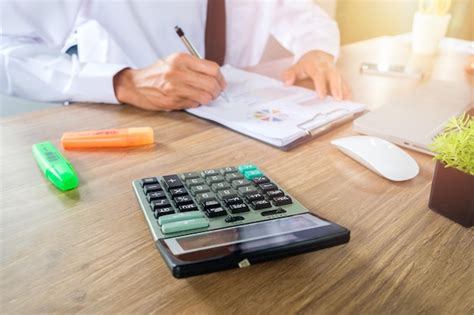 Premium Photo Midsection Of Businessman Working On Table