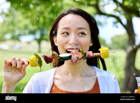 Japanese Woman Having Barbecue At City Park Stock Photo Alamy