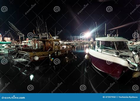 Night Shot Of Wooden And Motorboats Moored At Sea Port Stock Photo