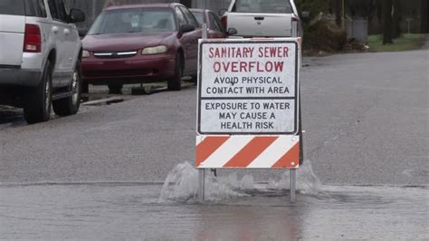 "Sanitary Sewer Overflow" bubbling out of manholes on 23rd Street - WDEF