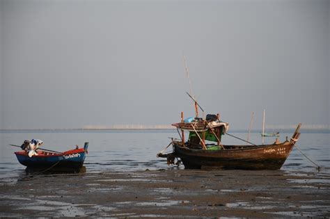 Premium Photo Fishing Boats Moored In Sea Against Sky