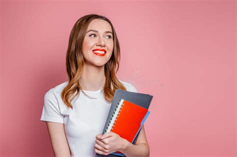 Happy Caucasian Student Girl Smiling Looks Away And Holding Notebooks