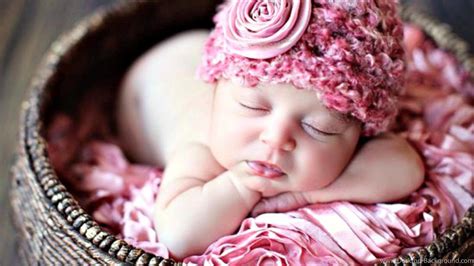 Cute Baby Is Sleeping Inside Bamboo Basket Having Flower Wreath On Head