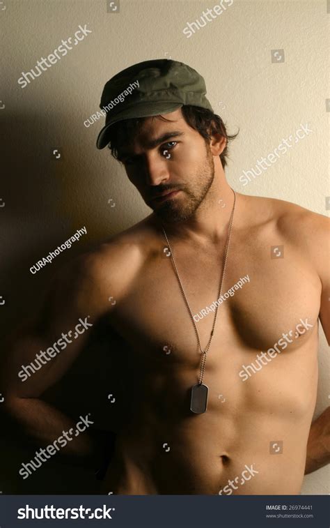 Warm Toned Portrait Of A Sexy Shirtless Military Man Wearing Hat And