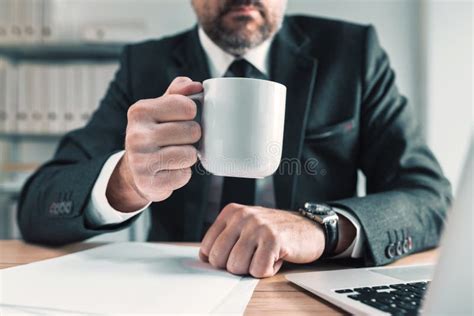 Elegant Male Business Person On Coffee Break In Office Stock Photo