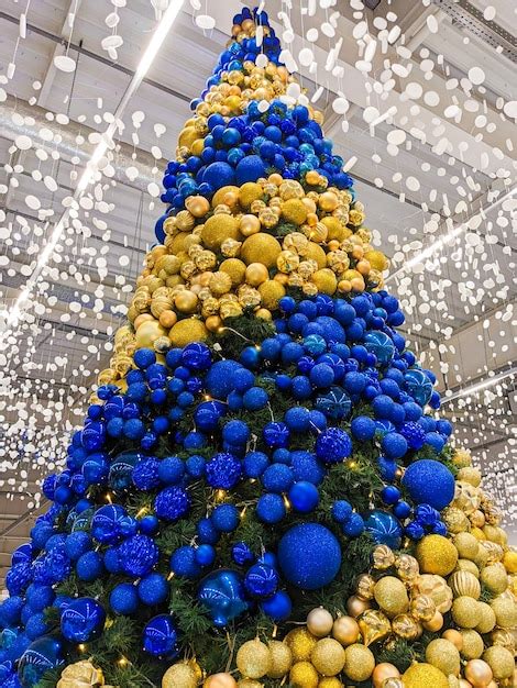 Premium Photo | A large Christmas tree with yellow and blue balls