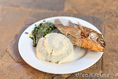 Traditional African Food - Ugali, Fish And Greens Stock Photo - Image: 83546723